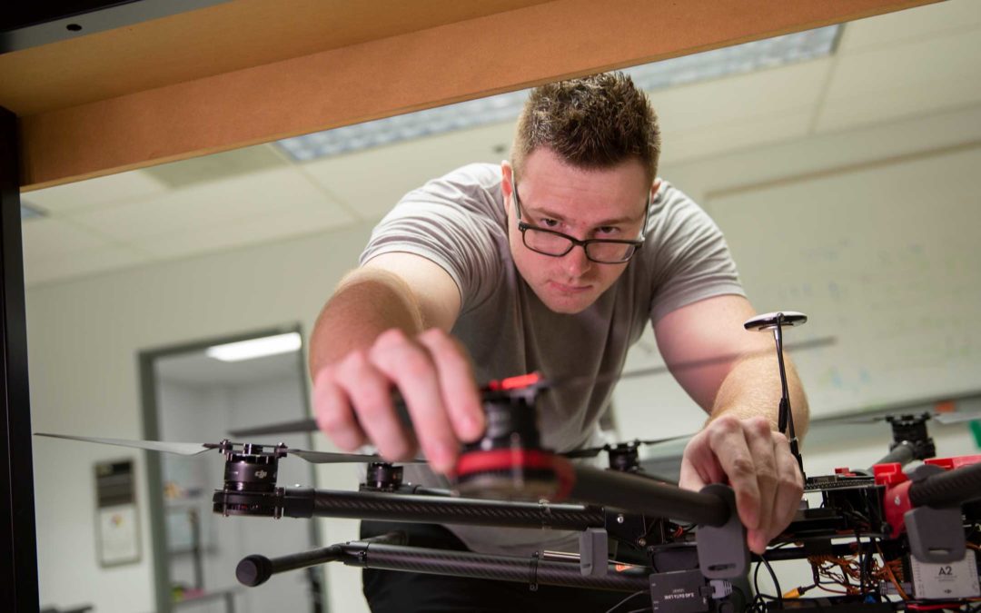 Andrew Herschfeldt, a grad student, works in his lab