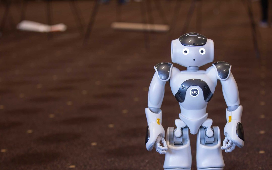 A small, humanoid robot stands looking ahead